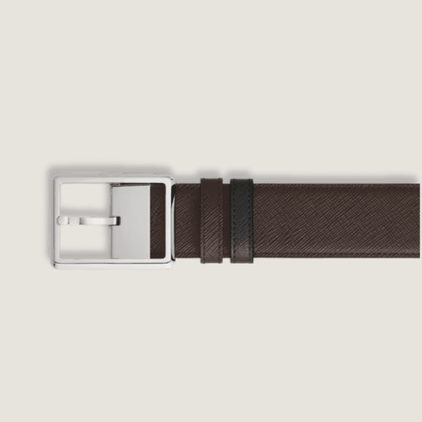 Cintura Montblanc Sartorial marrone con finitura goffrata e fibbia rettangolare lucida, doppio passante nero/marrone su fondo beige.